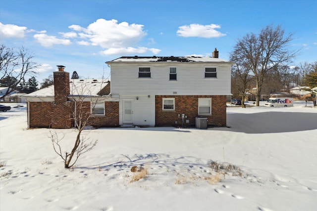 snow covered house with central AC unit