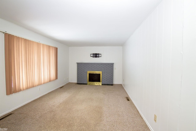 unfurnished living room with a fireplace and carpet floors