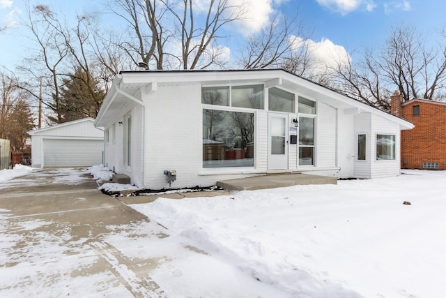 view of front facade featuring a garage and an outdoor structure