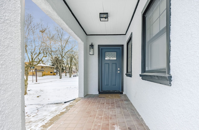 view of snow covered property entrance