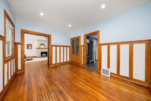 corridor with hardwood / wood-style flooring