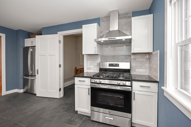 kitchen featuring ventilation hood, appliances with stainless steel finishes, white cabinets, and backsplash