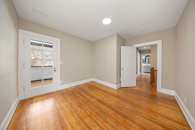 unfurnished room featuring hardwood / wood-style flooring