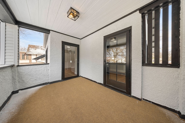 unfurnished sunroom featuring wooden ceiling