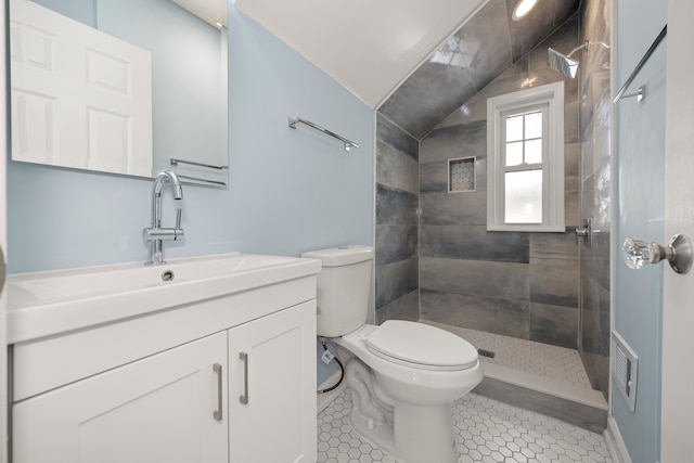 bathroom with vanity, lofted ceiling, tile patterned floors, and toilet