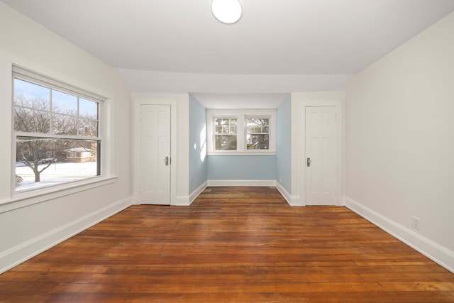 spare room with dark wood-type flooring