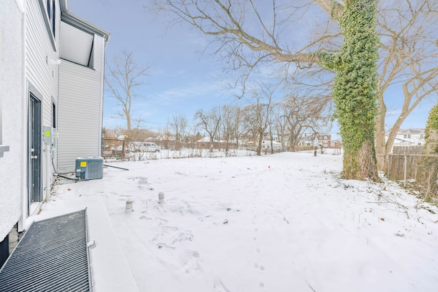 yard covered in snow with central AC unit