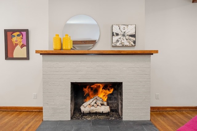 details with hardwood / wood-style flooring and a fireplace