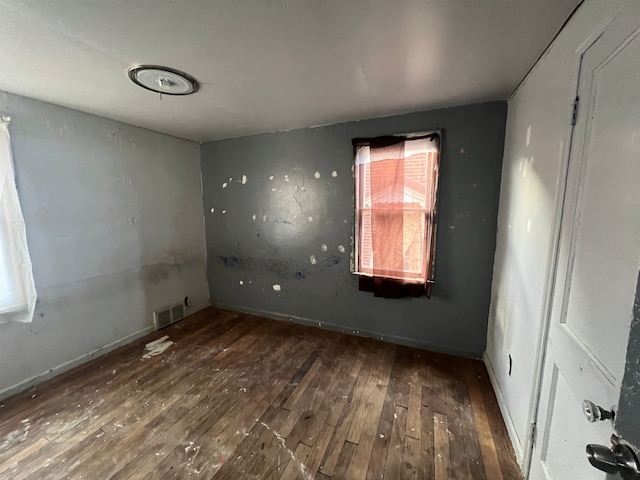 spare room with dark hardwood / wood-style flooring