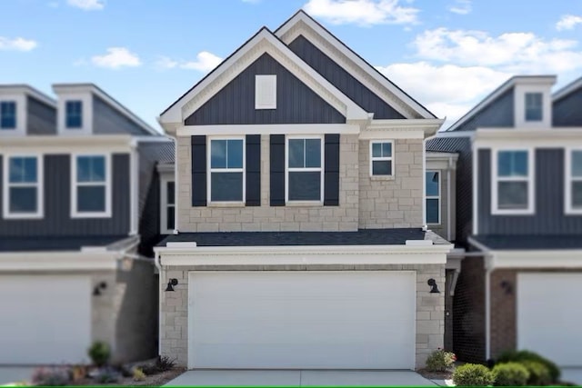 view of front of home with board and batten siding, stone siding, and concrete driveway