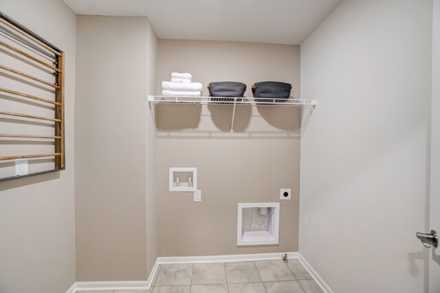 clothes washing area featuring washer hookup, light tile patterned floors, electric dryer hookup, and gas dryer hookup