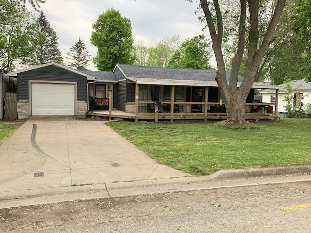 view of front of home with a garage, covered porch, and a front lawn