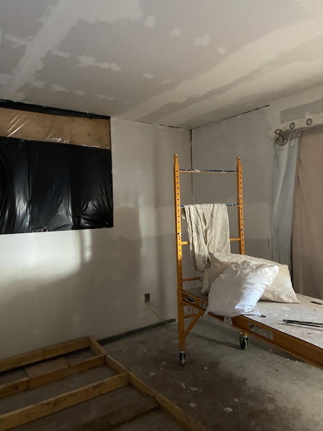 unfurnished bedroom featuring concrete flooring