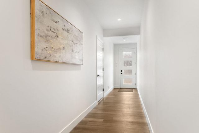 corridor with wood-type flooring