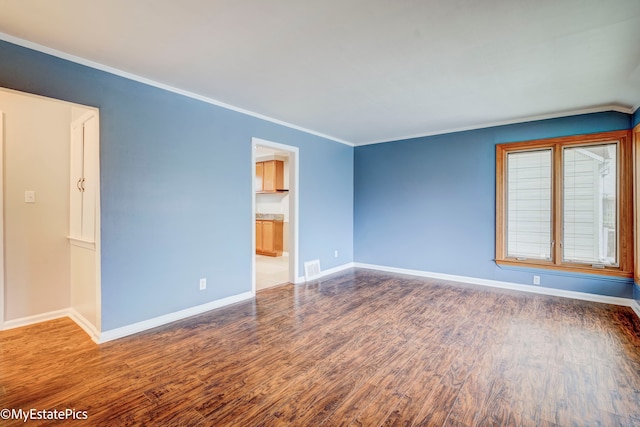 unfurnished room with crown molding and dark wood-type flooring