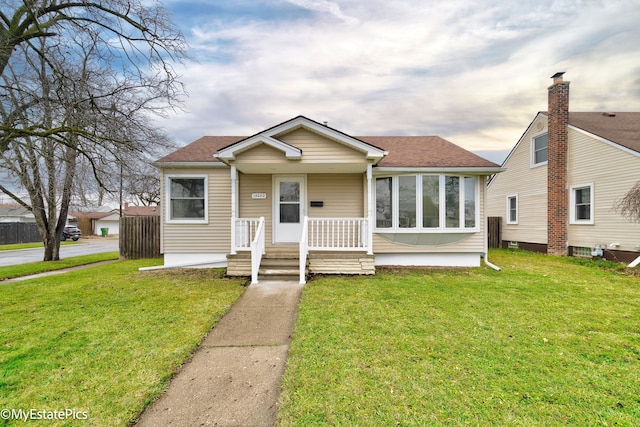 bungalow-style house featuring a front lawn