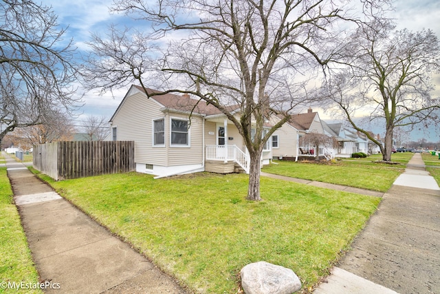 bungalow-style house featuring a front lawn