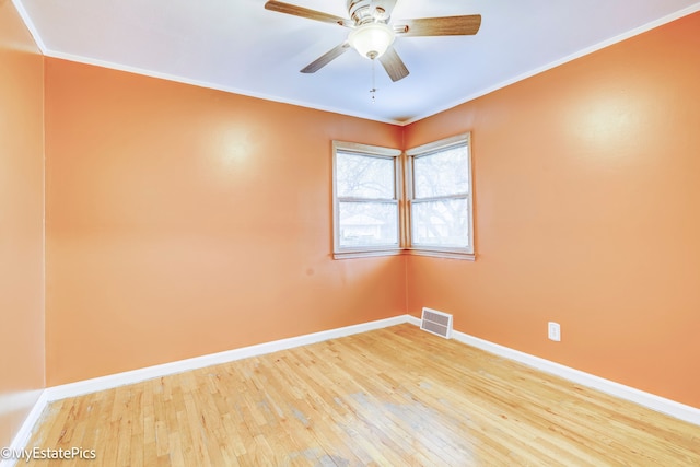 unfurnished room with hardwood / wood-style flooring, ceiling fan, and crown molding