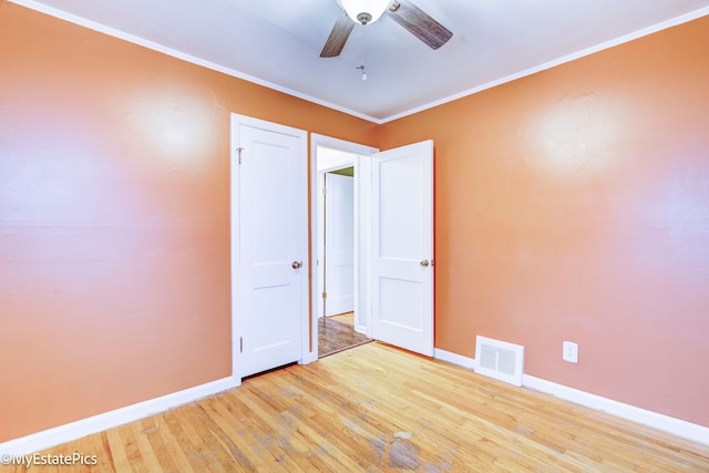 unfurnished bedroom with crown molding, light hardwood / wood-style flooring, and ceiling fan