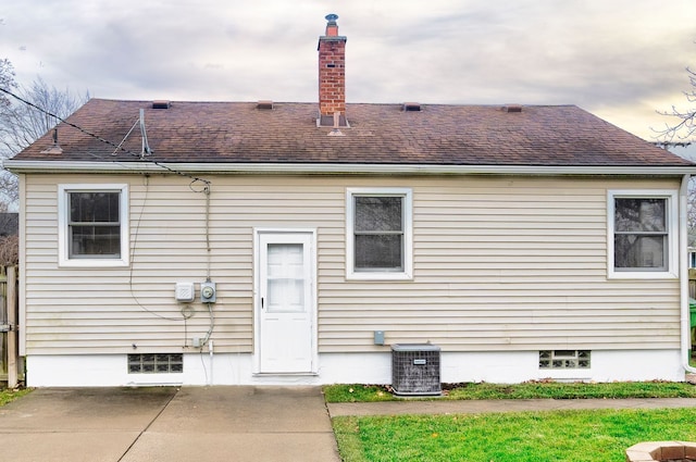 rear view of property with central AC and a patio area