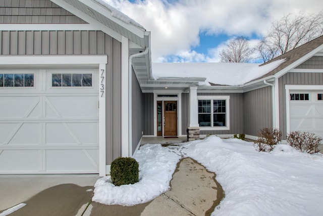 view of snow covered property entrance