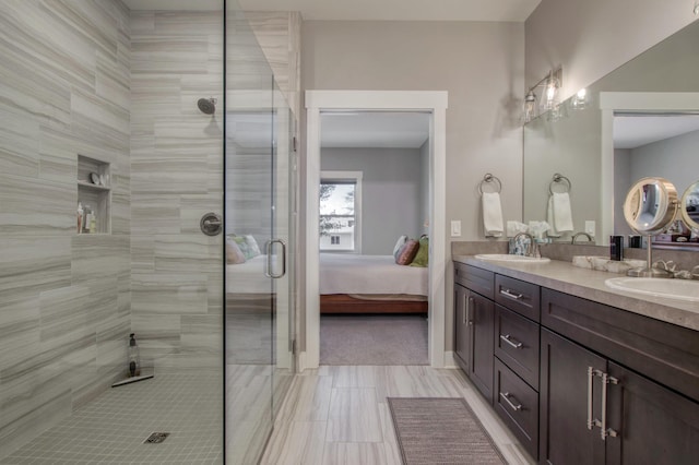 bathroom with vanity and a shower with door