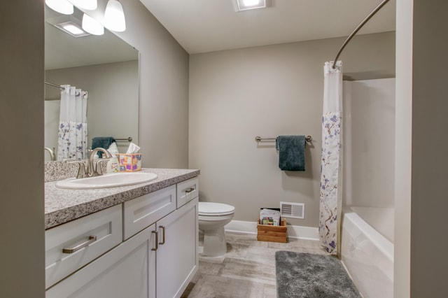 full bathroom featuring shower / tub combo, vanity, and toilet