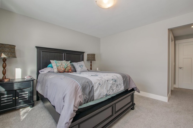 bedroom featuring light colored carpet