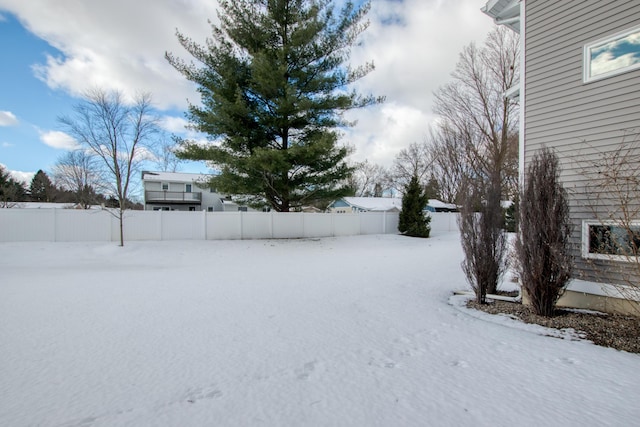 view of yard layered in snow