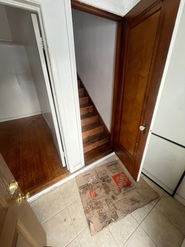 stairway featuring tile patterned flooring