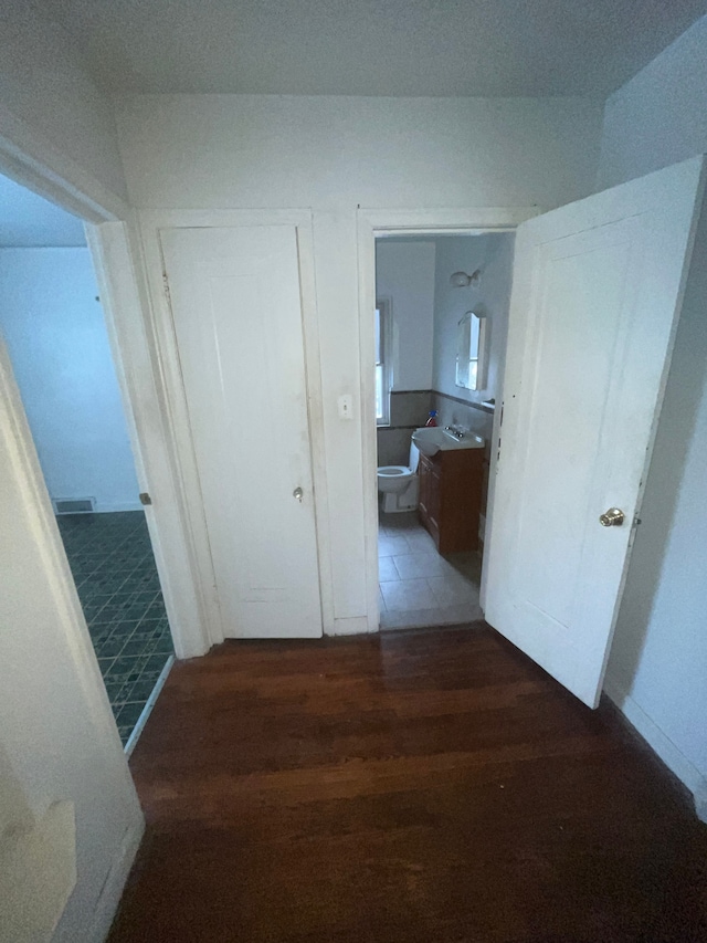 corridor with dark wood-style floors