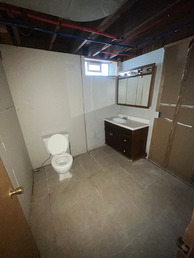 bathroom featuring toilet and vanity