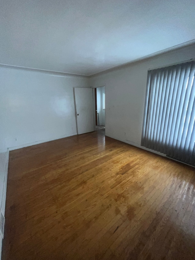 spare room featuring wood finished floors