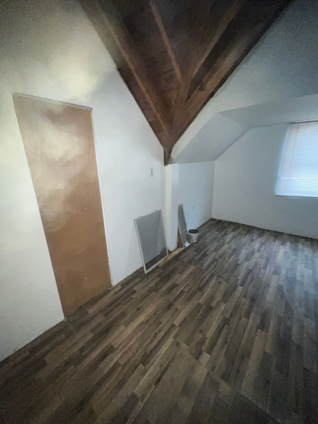 additional living space with dark wood-style floors and lofted ceiling