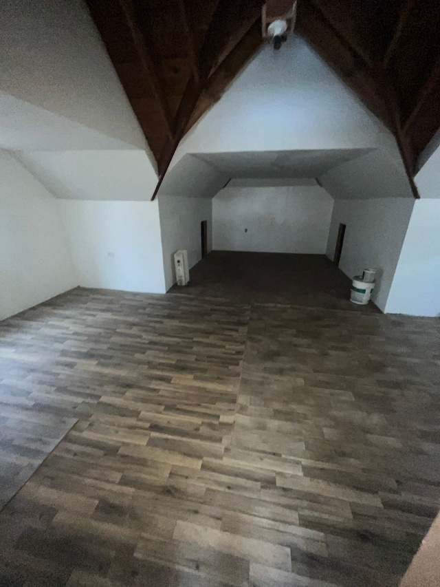 additional living space featuring lofted ceiling and wood finished floors