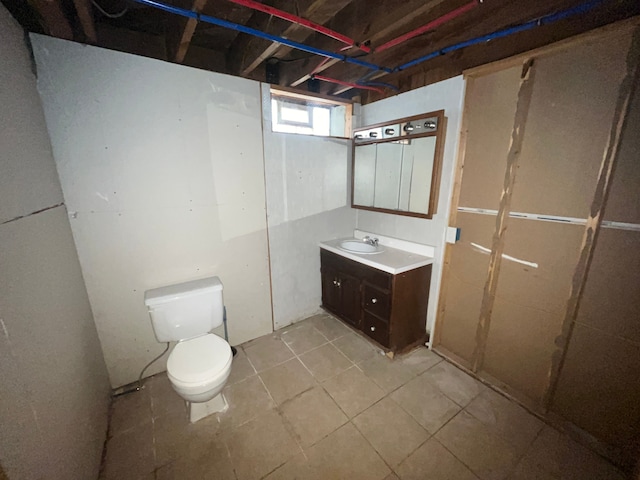bathroom featuring toilet, vanity, and tile patterned flooring