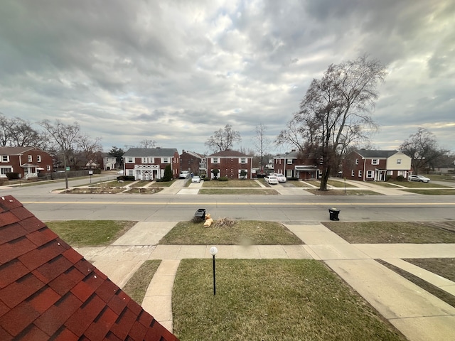 view of street featuring curbs, a residential view, and sidewalks