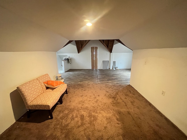 additional living space featuring vaulted ceiling and carpet