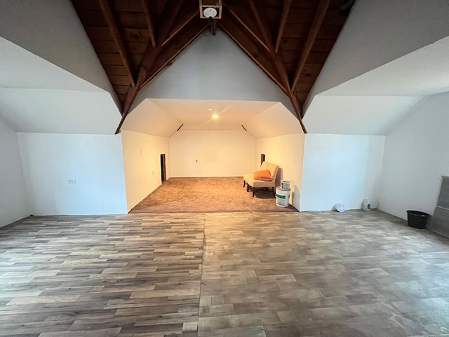 additional living space with vaulted ceiling and wood finished floors