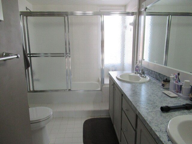 full bathroom with vanity, toilet, and combined bath / shower with glass door