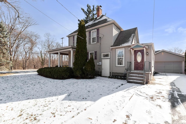 view of front of property featuring a garage and an outdoor structure