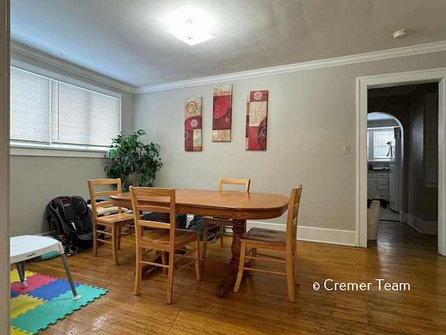 dining area with ornamental molding and hardwood / wood-style floors