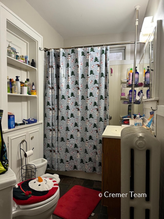 bathroom featuring vanity, tile patterned floors, and toilet