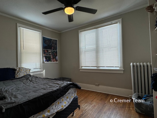 bedroom with multiple windows, radiator, crown molding, and ceiling fan