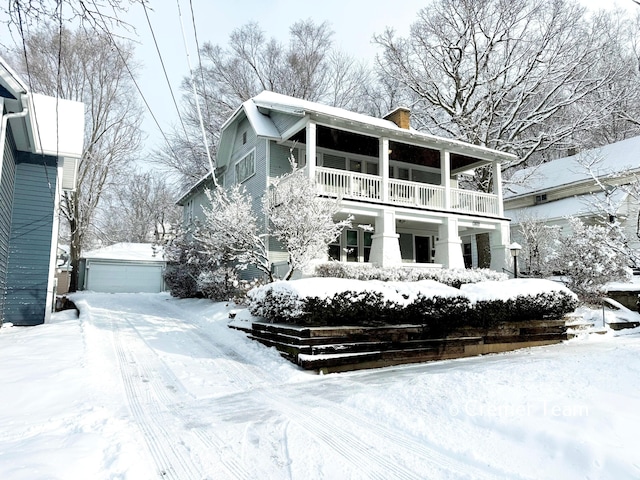 exterior space with a garage, a balcony, and an outdoor structure