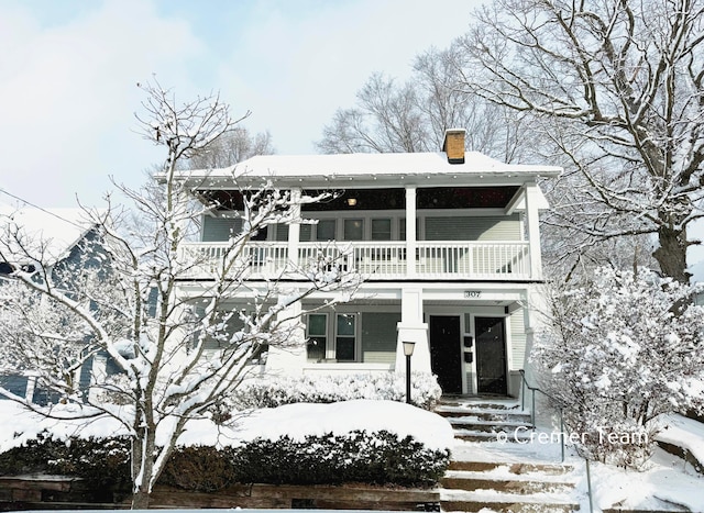 view of front of home with a balcony and covered porch