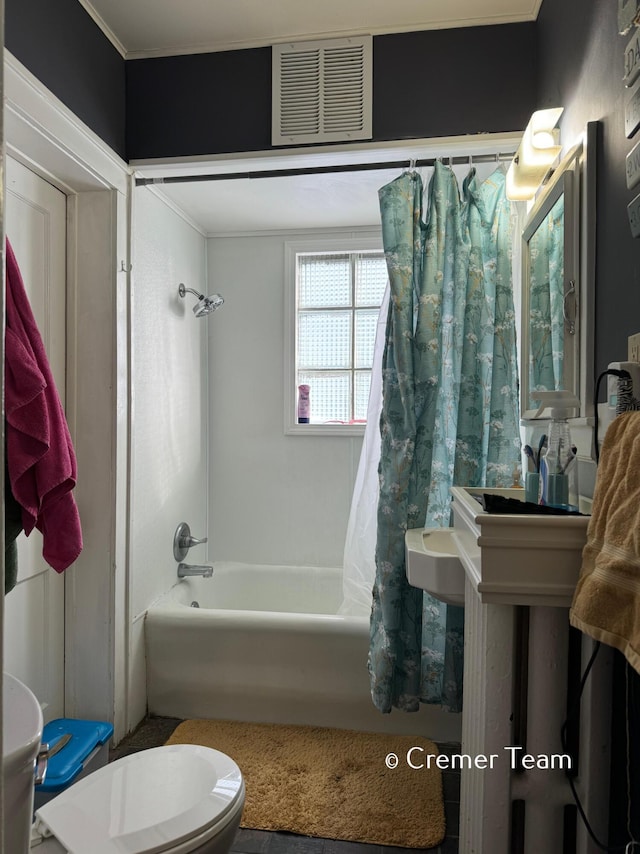 bathroom featuring shower / bath combination with curtain and toilet