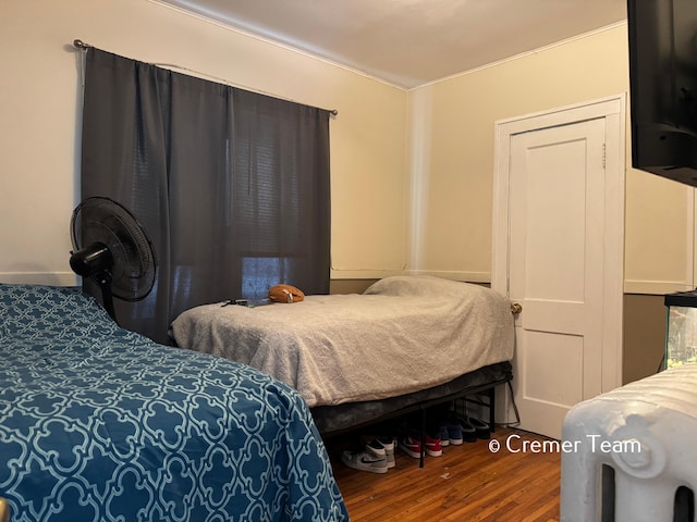 bedroom with hardwood / wood-style flooring