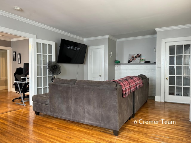 living room featuring crown molding and wood-type flooring