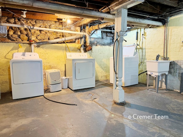 basement featuring separate washer and dryer and sink